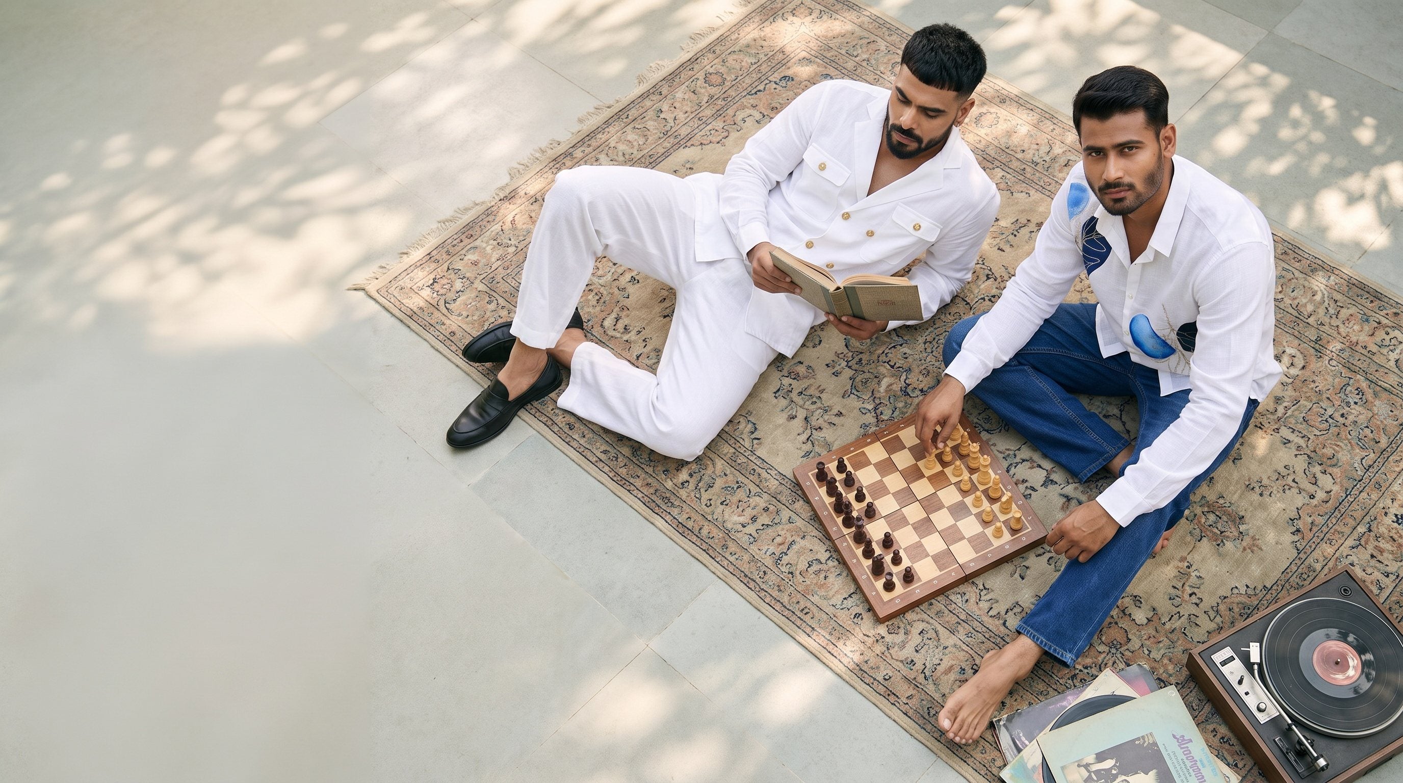 Two men on a rug, from above, one in the Regent Resort Co-ord, one in the Azure Leaf Shirt