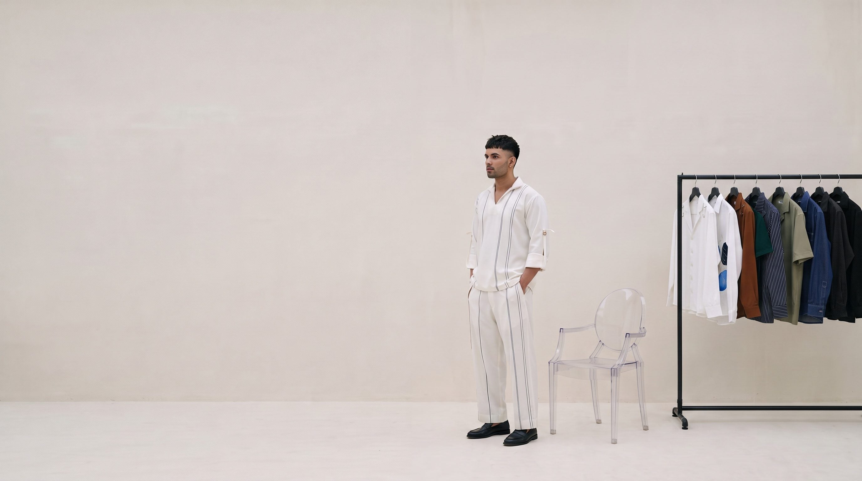 The Monaco Piped Co-ord in an empty white room beside a rail